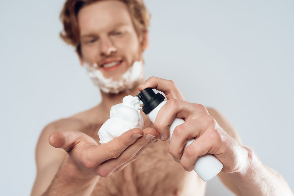 man applies shaving cream