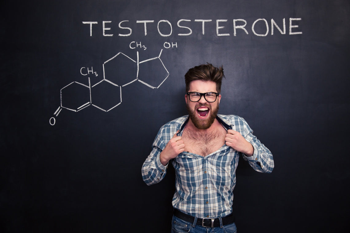 Young man tearing his shirt against blackboard with testosterone formula