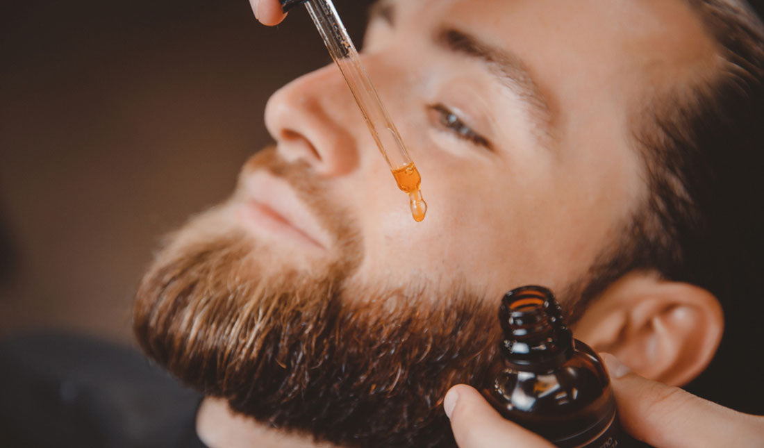 barber applying beard oil
