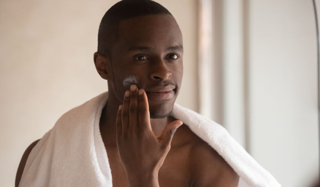 black man applying shaving cream