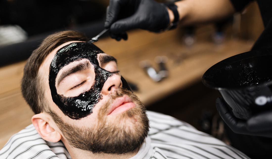 charcoal mask applied to guy's face