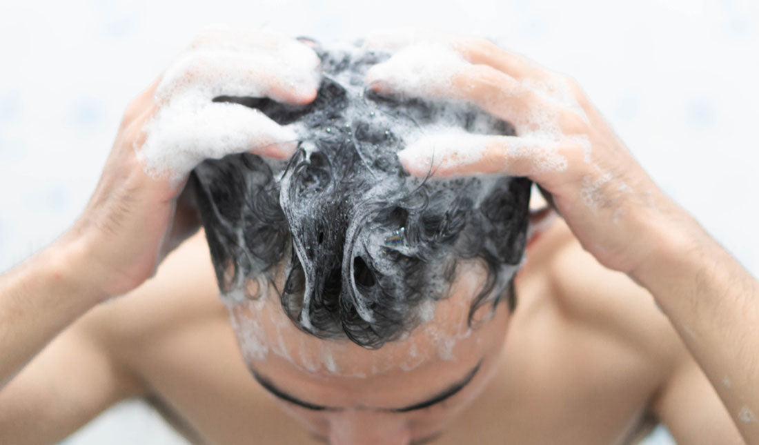 closeup man shampooing scalp