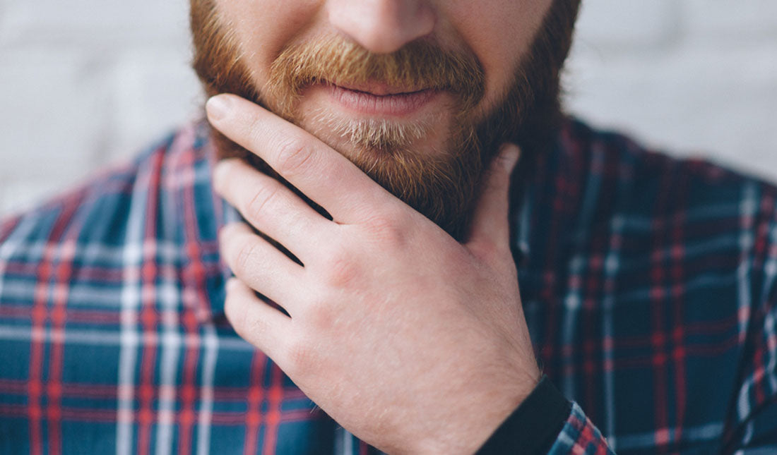 closeup man touching beard
