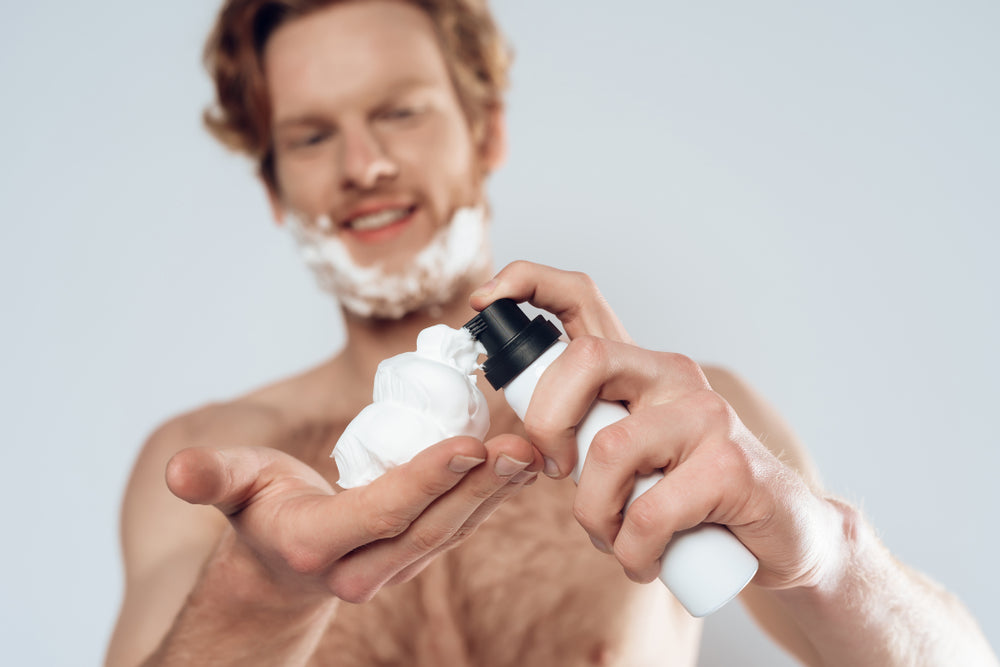 man applies shaving cream
