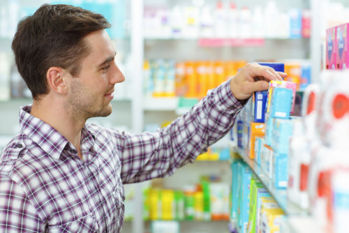 man choosing products in drugstore
