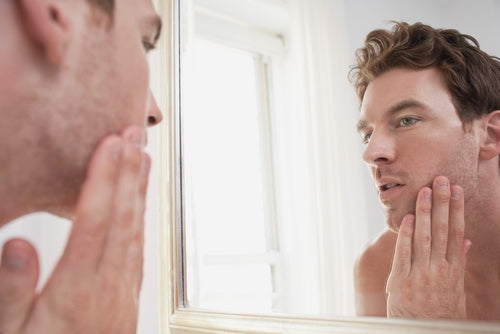 man examining his stubble