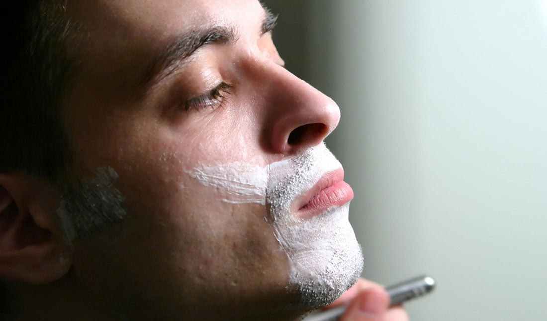 man shaving in the morning