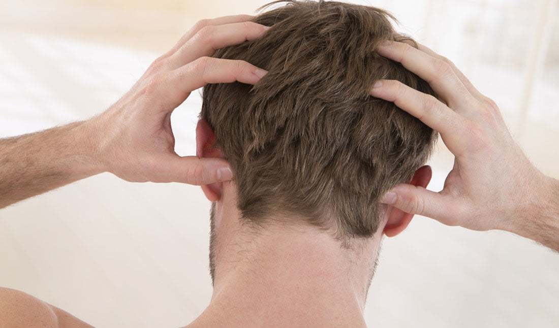 man suffering from itchy scalp
