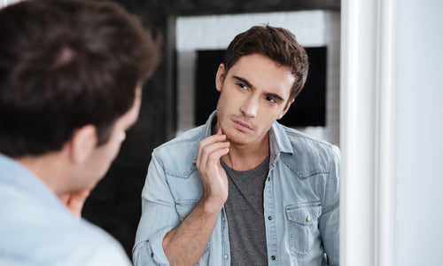 man touching his face