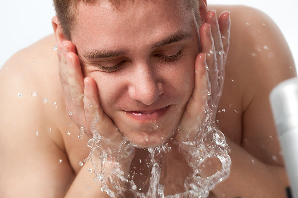 man washing face