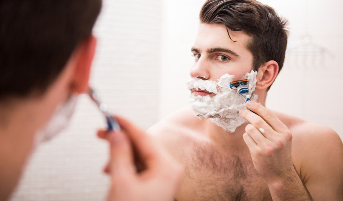 shaving face using mirror
