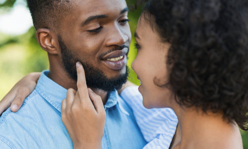 woman touching face of bearded husband