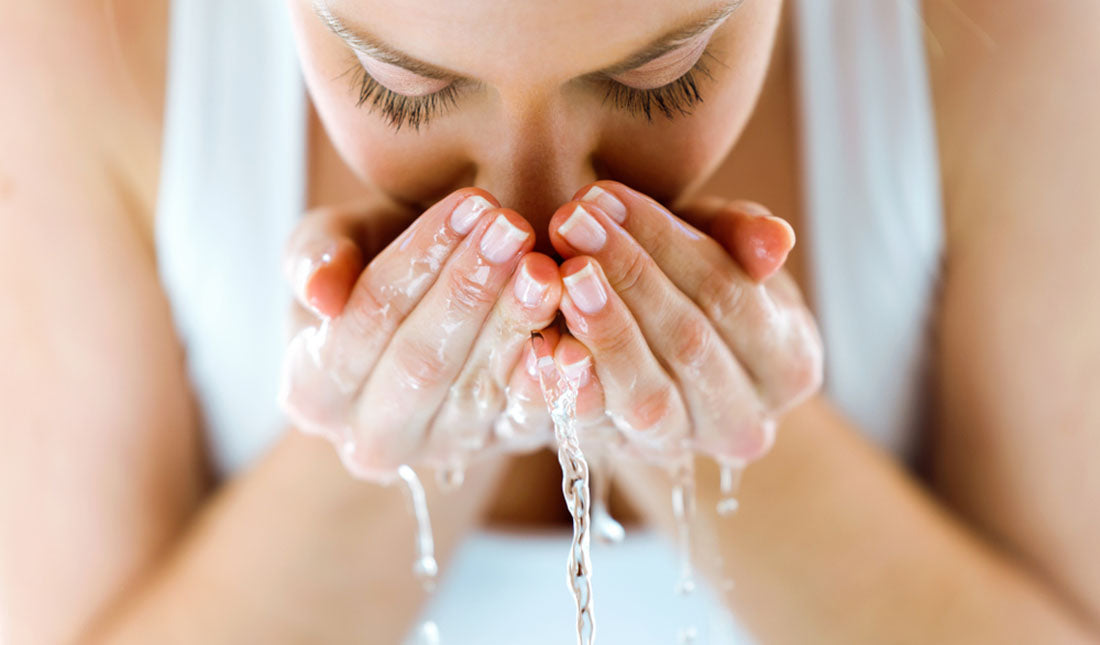 woman washing her face