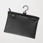A black waterproof travel pouch with a hanging hook, featuring a zipper closure and branded with the Tiege Hanley logo.