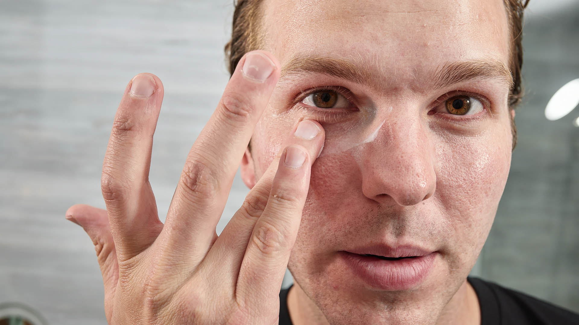 Man applying Eye cream